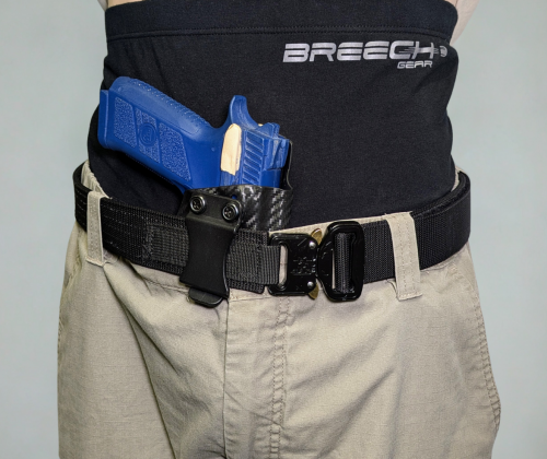 Close-up of the Breech Gear concealed carry briefs worn under khackis, a belt, with a blue demo pistol secured inside.